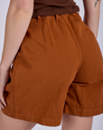 Close up back view of Pleated Trouser Shorts in Burnt Terracotta on Alex
