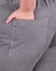 Close up of Marielena's hand in the back pocket of Short Sleeve Jumpsuit in Washed Grey