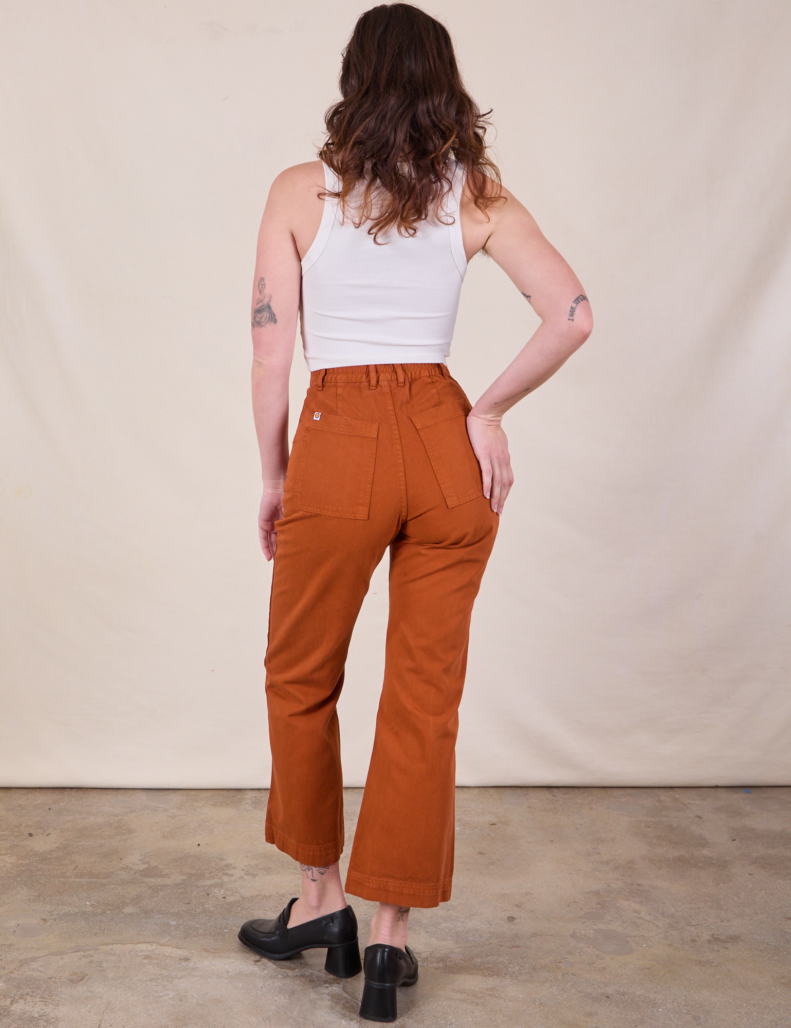 Back view of Western Pants in Burnt Terracotta and Cropped Tank in Vintage Tee Off-White on Alex