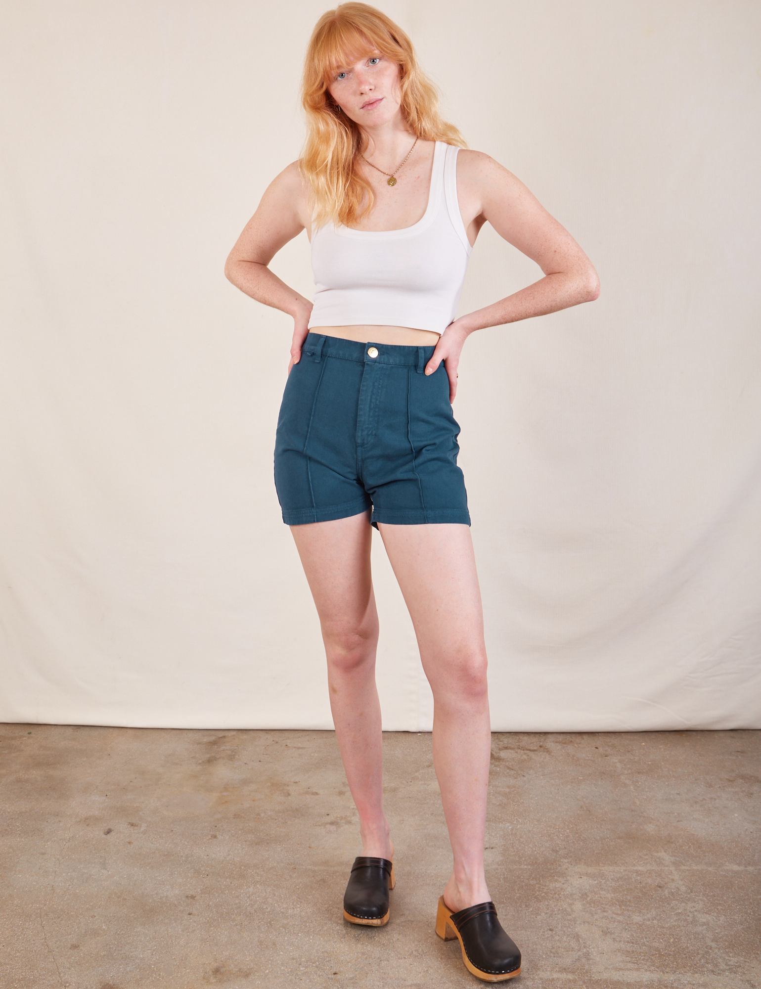 Margaret is 5&#39;11&quot; and wearing XS Western Shorts in Lagoon paired with Cropped Tank in vintage tee off-white