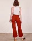 Back view of Western Pants in Paprika and vintage off-white Tank Top worn by Alex