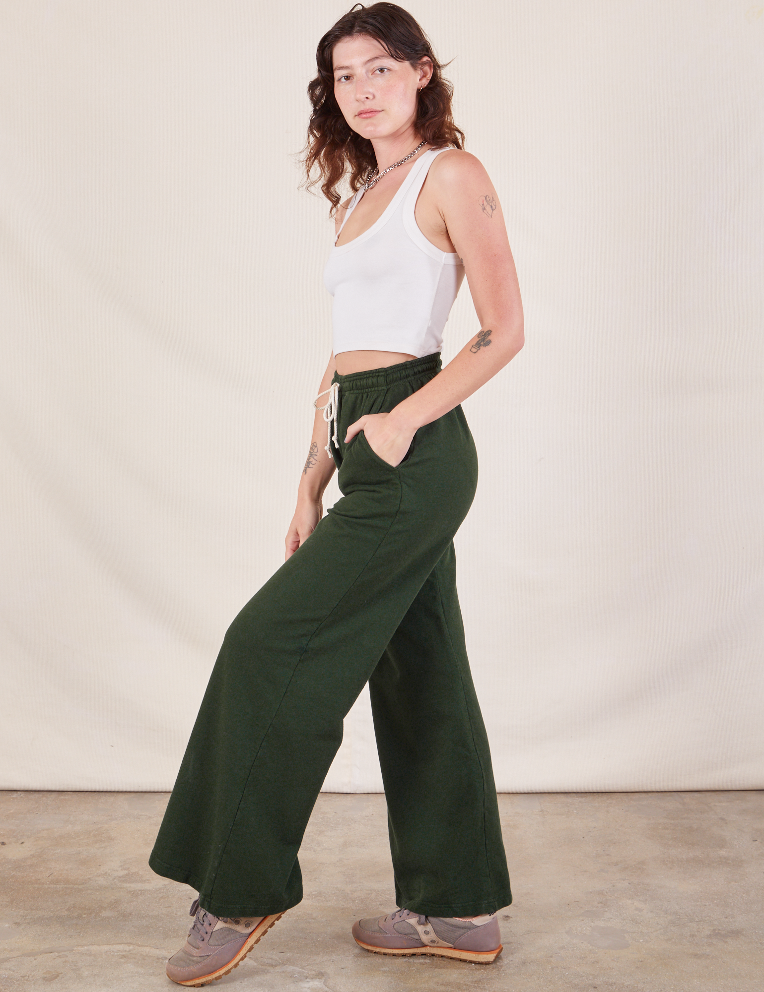 Side view of Wide Leg Sweat Pants in Swamp Green and Cropped Tank on Alex