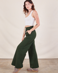 Side view of Wide Leg Sweat Pants in Swamp Green and Cropped Tank on Alex