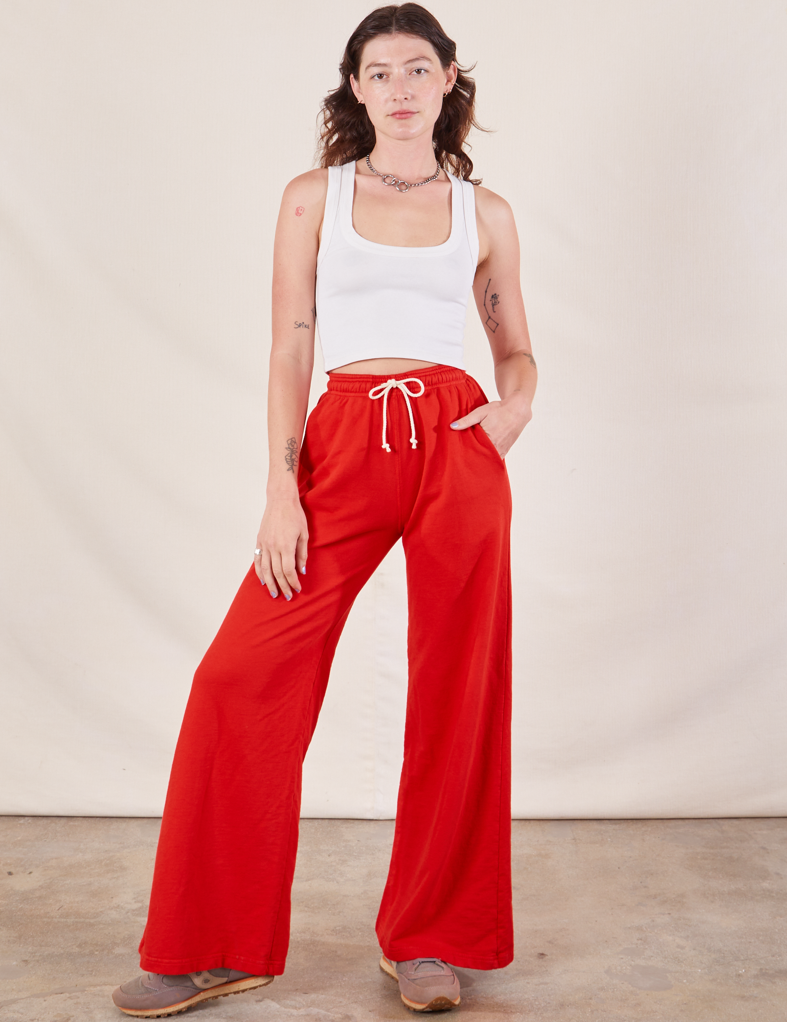 Alex is 5&#39;8&quot; and wearing P Wide Leg Sweat Pants in Mustang Red paired with a Cropped Tank in vintage tee off-white