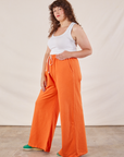 Wide Leg Sweat Pants in Sunset Orange side view on Ryan