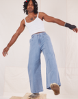 Jerrod is 6'3" and wearing S Indigo Wide Leg Trousers in Light Wash paired with vintage off-white Cami
