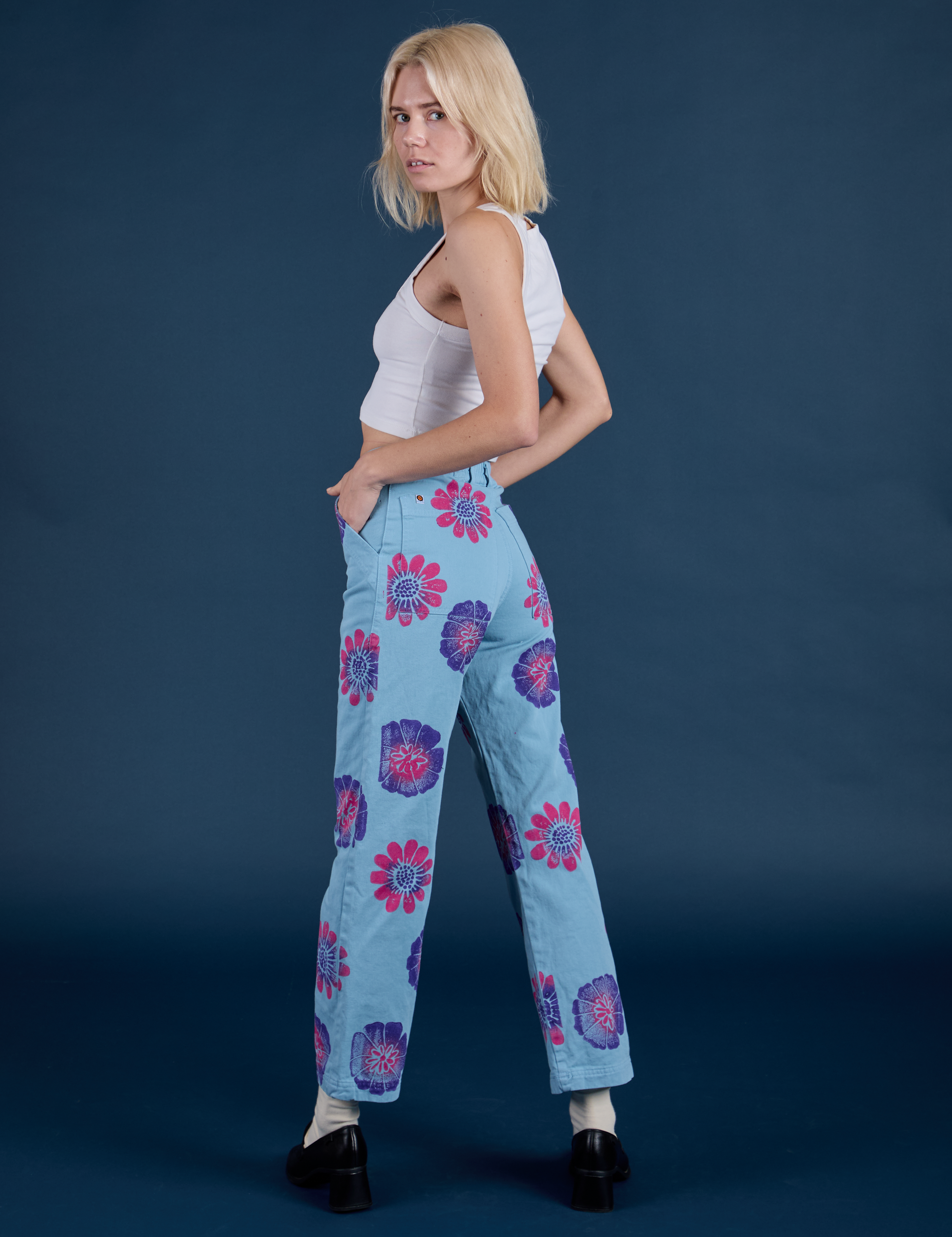 Angled back view of Floral Painted Work Pants in Blue on Madeline