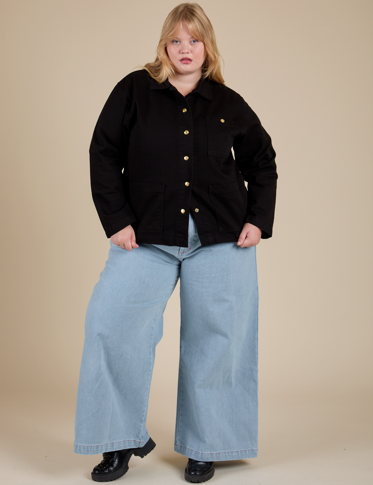 Juliet is wearing Work Jacket in Basic Black and light wash Indigo Wide Leg Trousers
