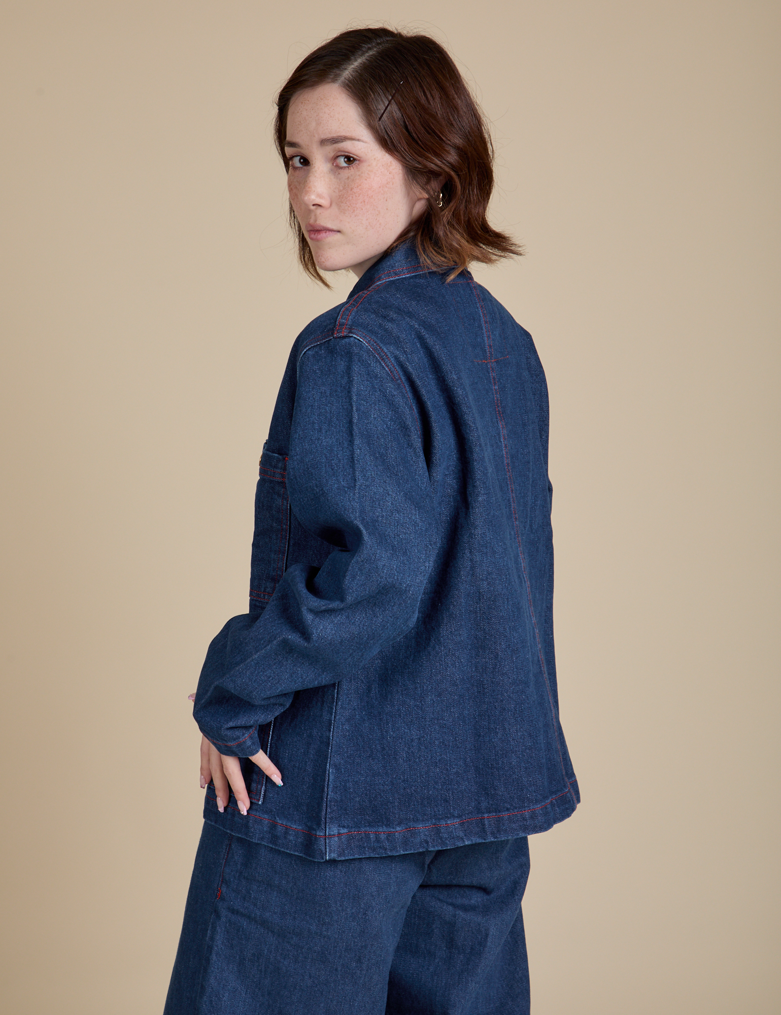 Angled back view of Indigo Denim Work Jacket in Dark Wash on Hana