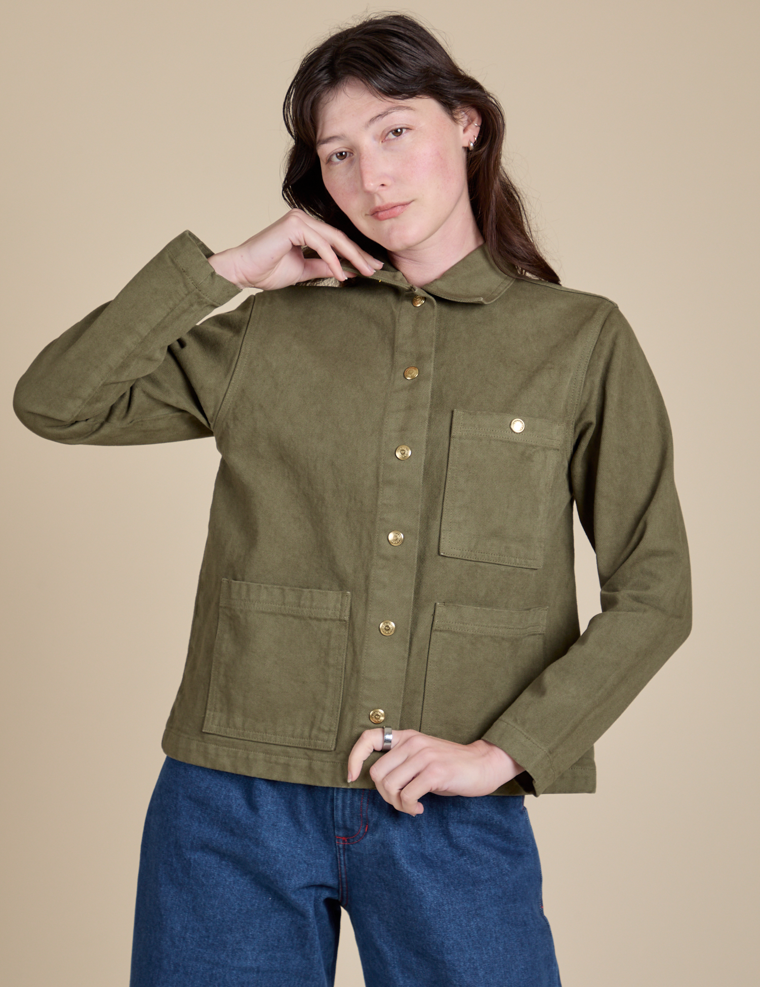 Alex is wearing a buttoned up Denim Work Jacket in Surplus Green