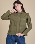Alex is wearing a buttoned up Denim Work Jacket in Surplus Green