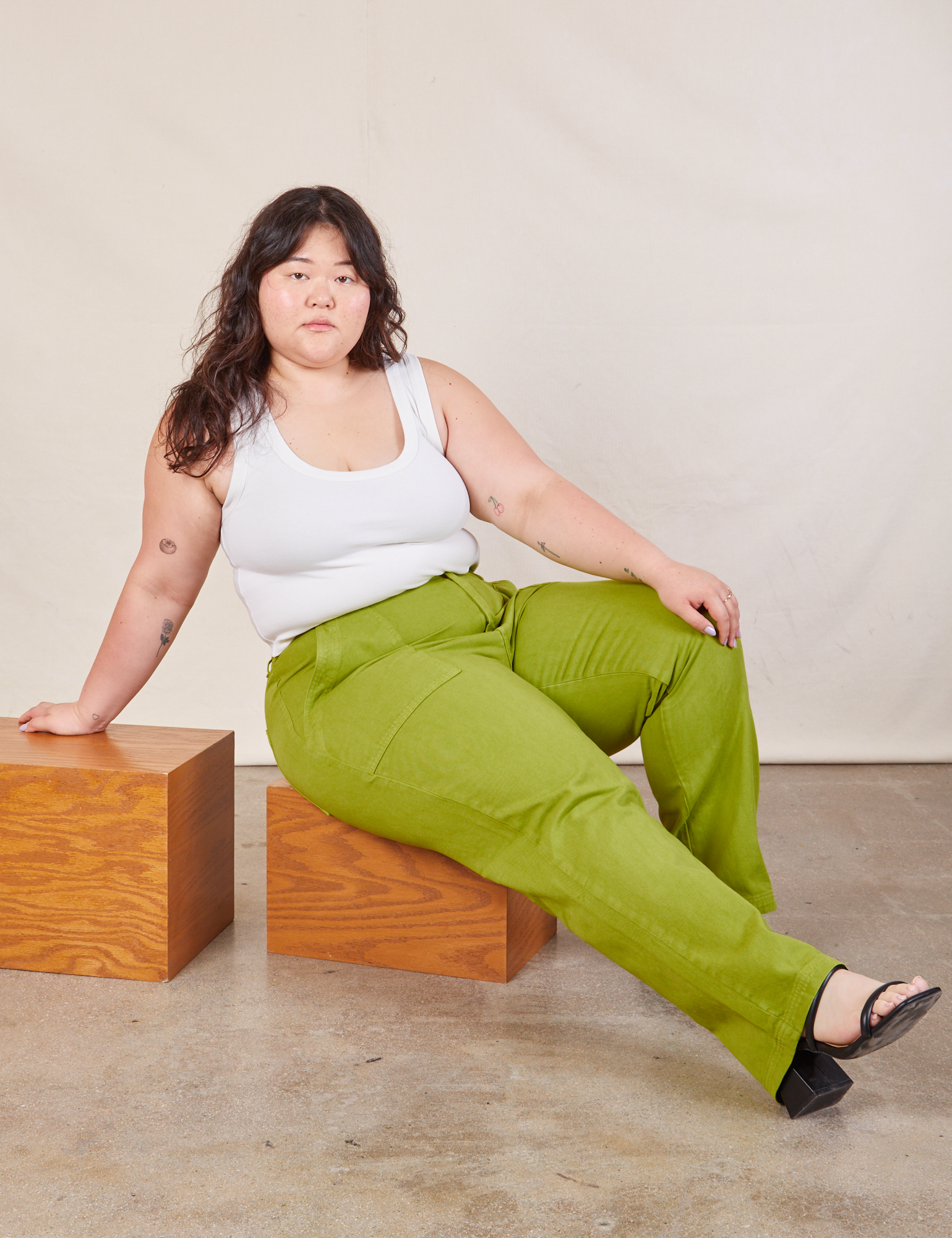 Ashley is wearing Work Pants in Gross Green and Cropped Tank in vintage tee off-white