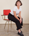Work Pants in Basic Black on Soraya sitting in vintage red and brass chair