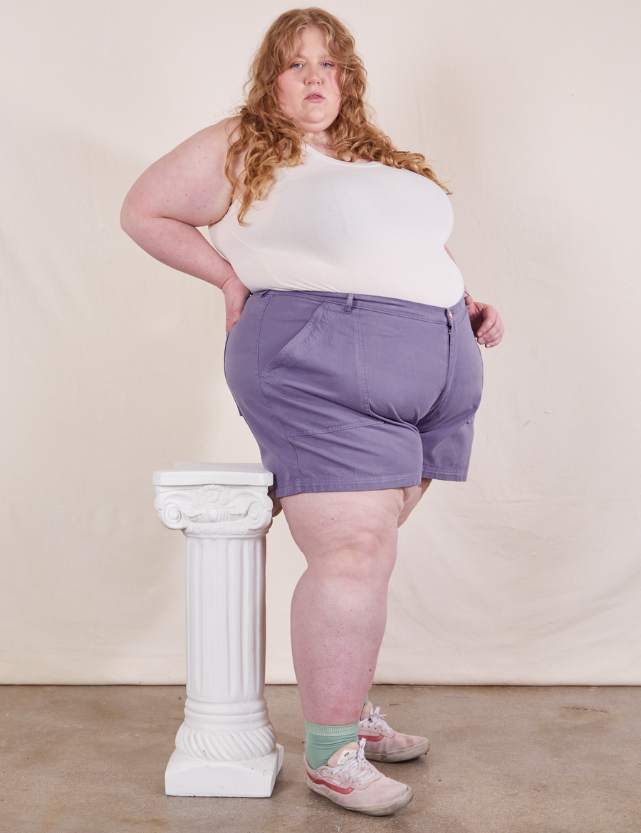 Angled view of Classic Work Shorts in Faded Grape and vintage off-white Tank Top worn by Catie