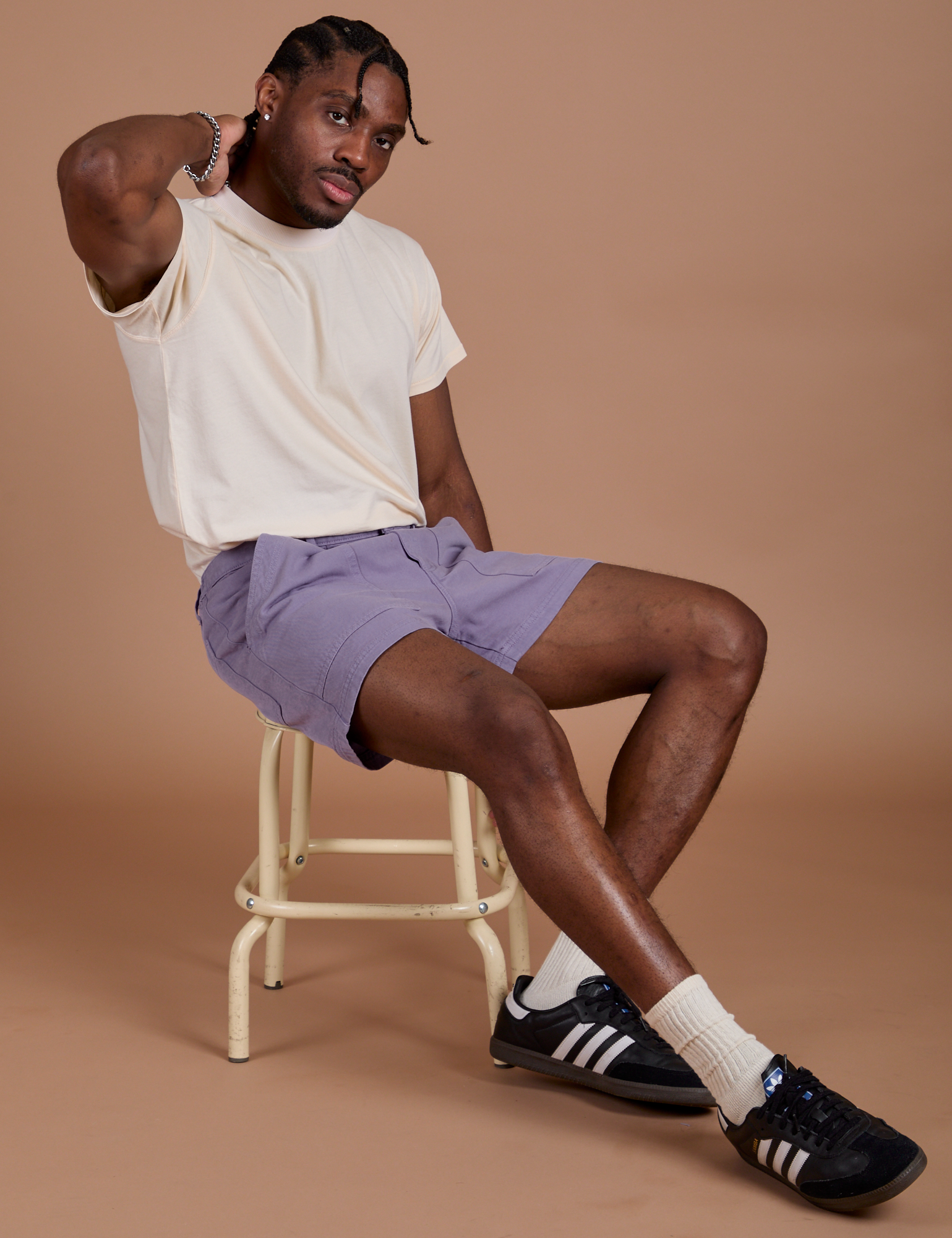 Isaac is wearing Classic Work Shorts in Faded Grape and Organic Vintage Tee in Vintage Tee Off-White