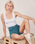 Madeline is wearing Classic Work Shorts in Marine Blue and a Cropped Tank Top in vintage tee off-white
