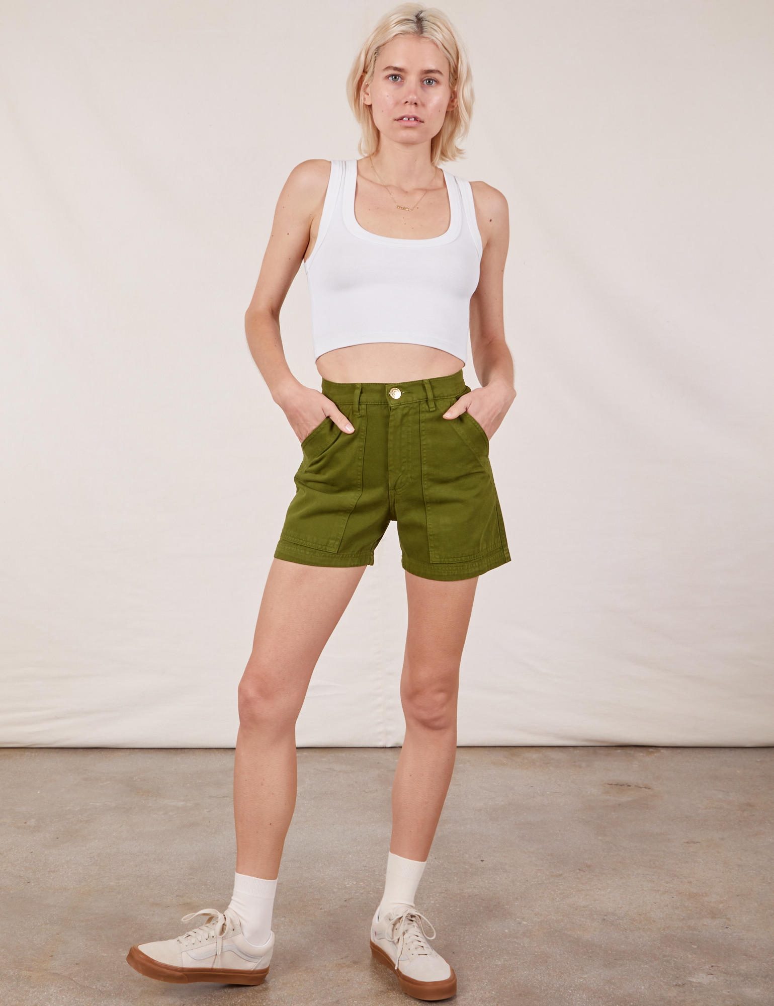 Madeline is 5’9” and wearing XXS Classic Work Shorts in Summer Olive paired with a Cropped Tank Top in vintage tee off-white