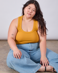 Ashley is wearing Cropped Tank Top in Mustard Yellow and light wash Indigo Wide Leg Trousers