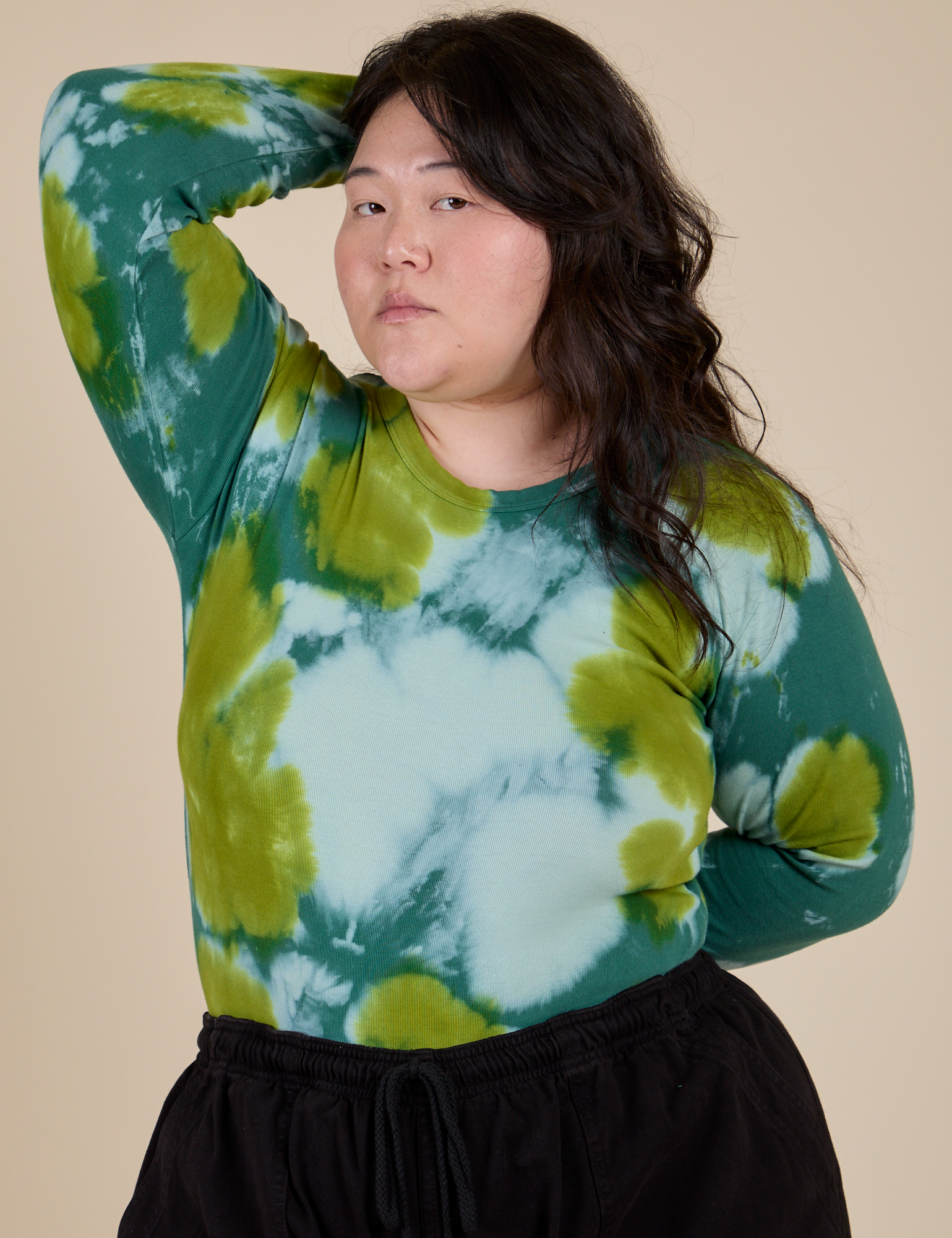 Ashley is wearing Long Sleeve Baby Tee in Green Magic Waters