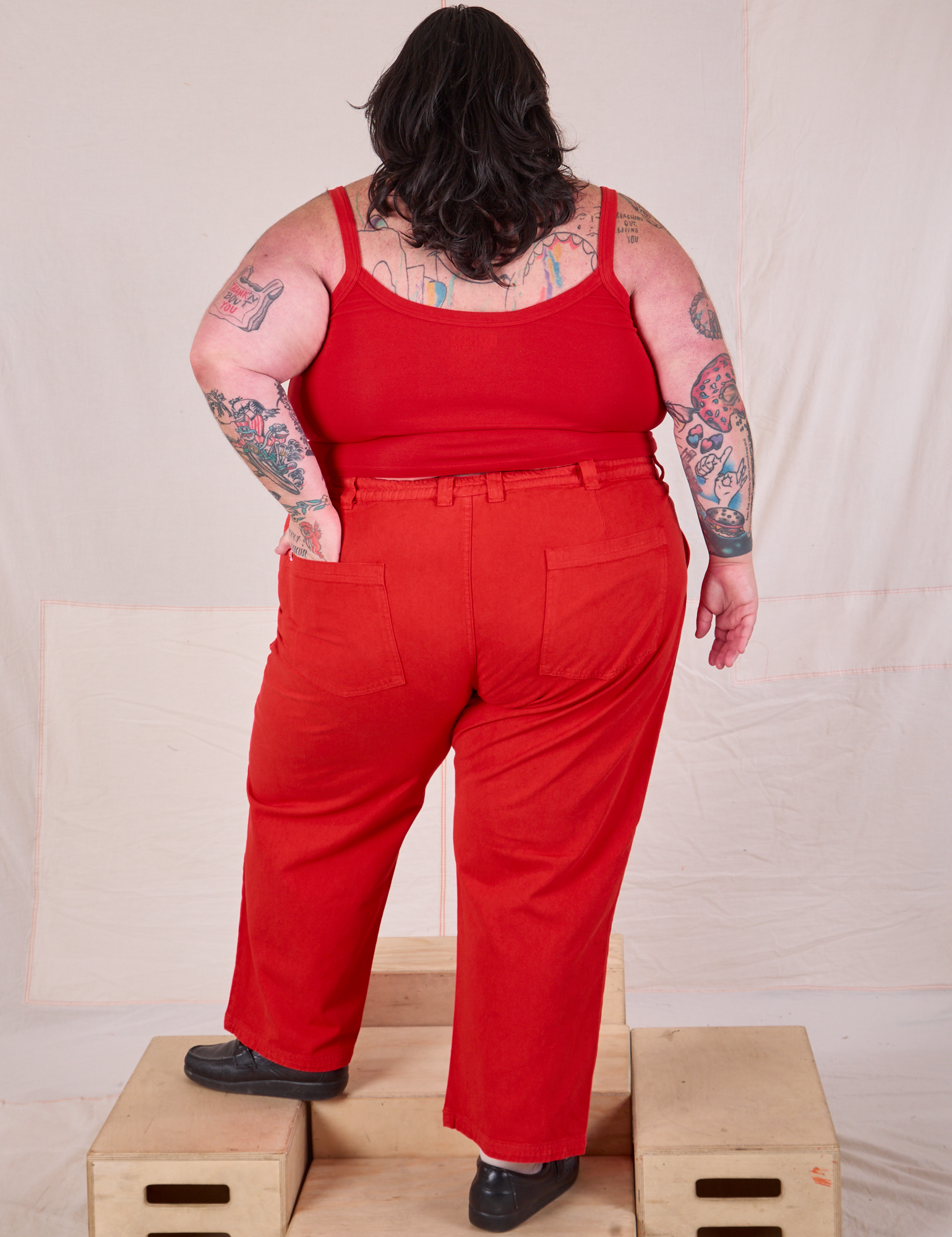 Back view of Mid-Rise Work Pants in Mustang Red and matching Cropped Cami on Sam