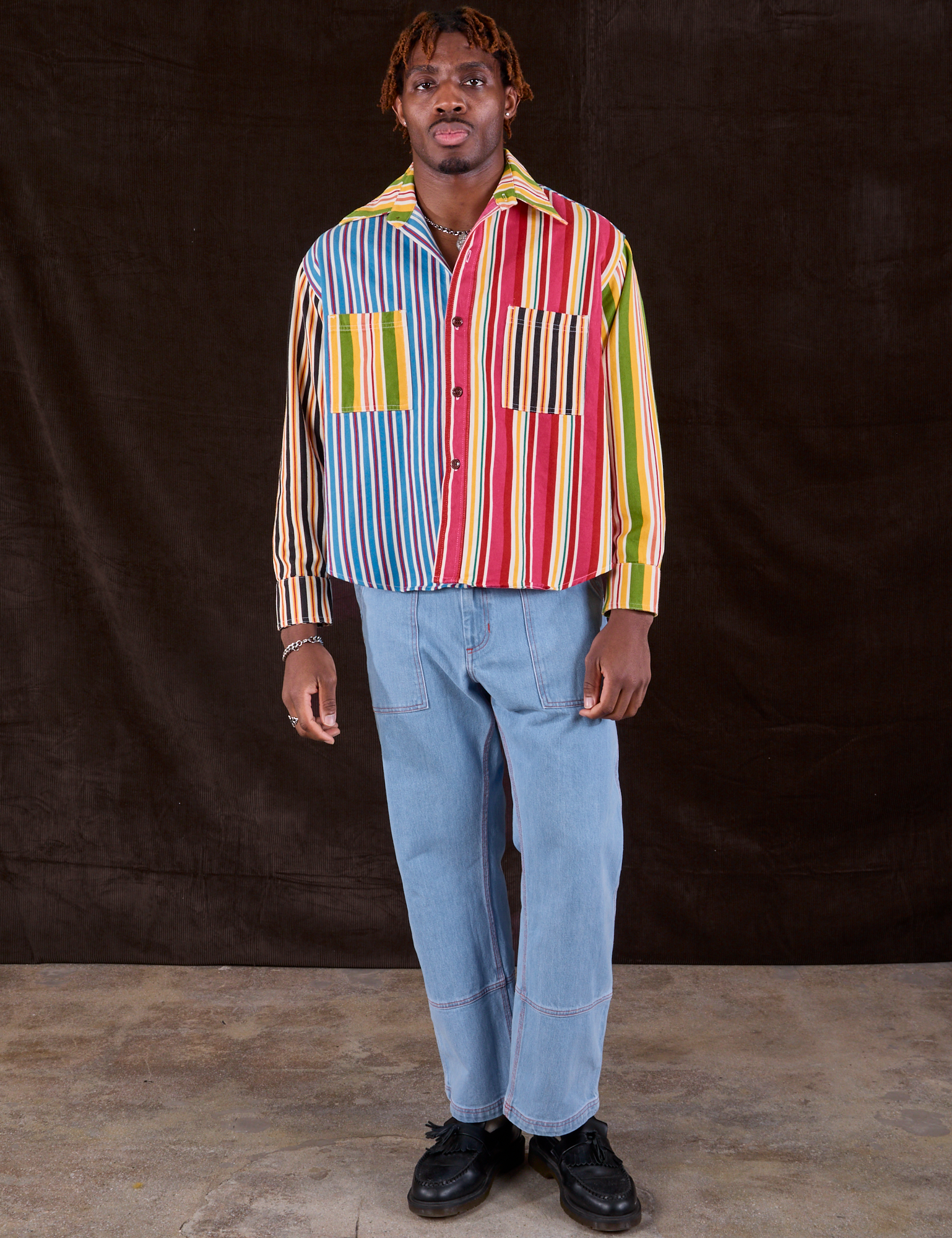 Isaac is wearing Cropped Overshirt in Mixed Stripe paired with light wash Carpenter Jeans