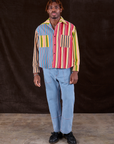 Isaac is wearing Cropped Overshirt in Mixed Stripe paired with light wash Carpenter Jeans