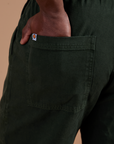 Close up of Demi's hand in the back pocket of Action Pants in Swamp Green