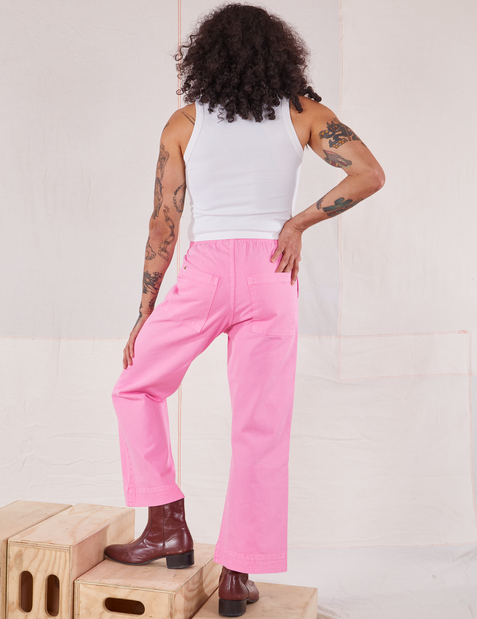 Back view of Action Pants in Bubblegum Pink and Cropped Tank in vintage tee off-white worn by Jesse