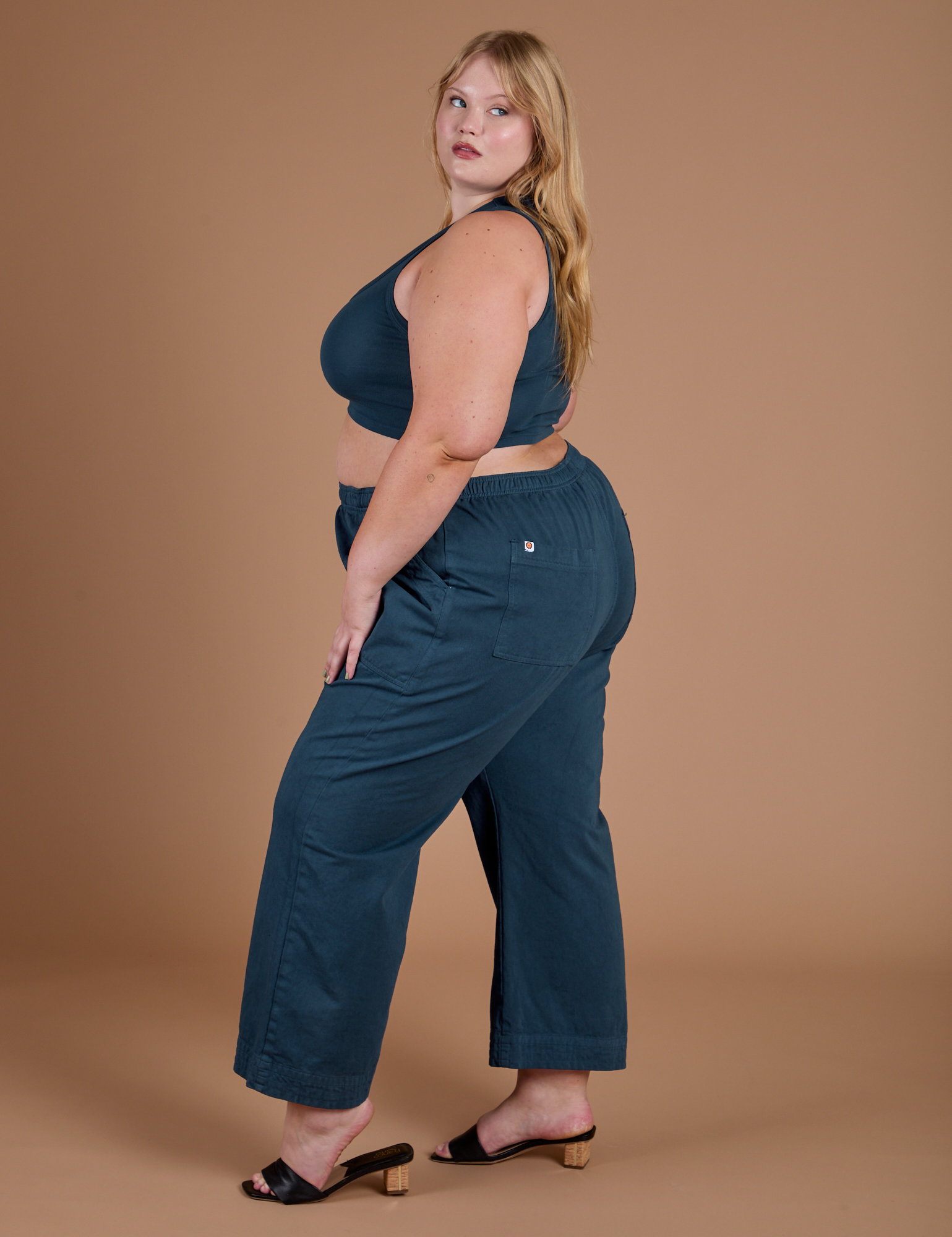 Side view of Action Pants in Lagoon and lagoon Mini Tank on Juliet