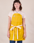 Alex is wearing Full Denim Apron in Sunshine Yellow