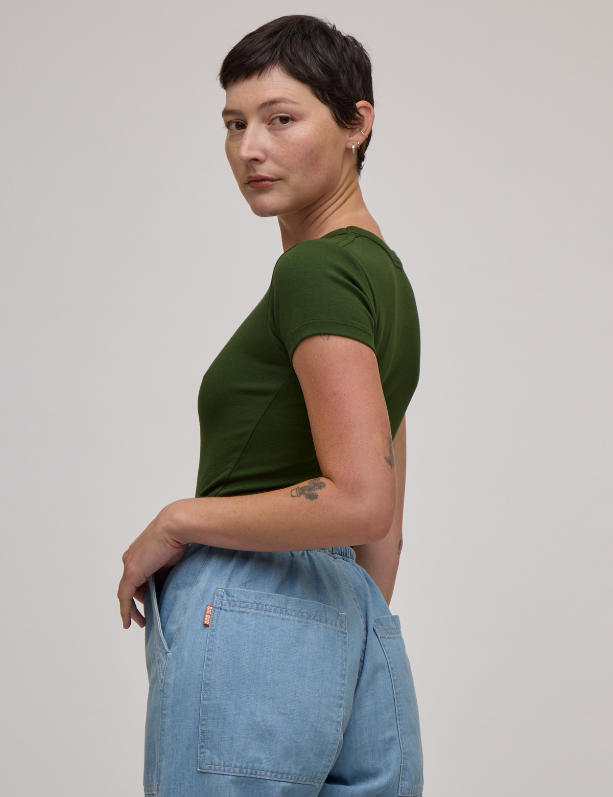 Side view of Baby Tee in Evergreen on Alex