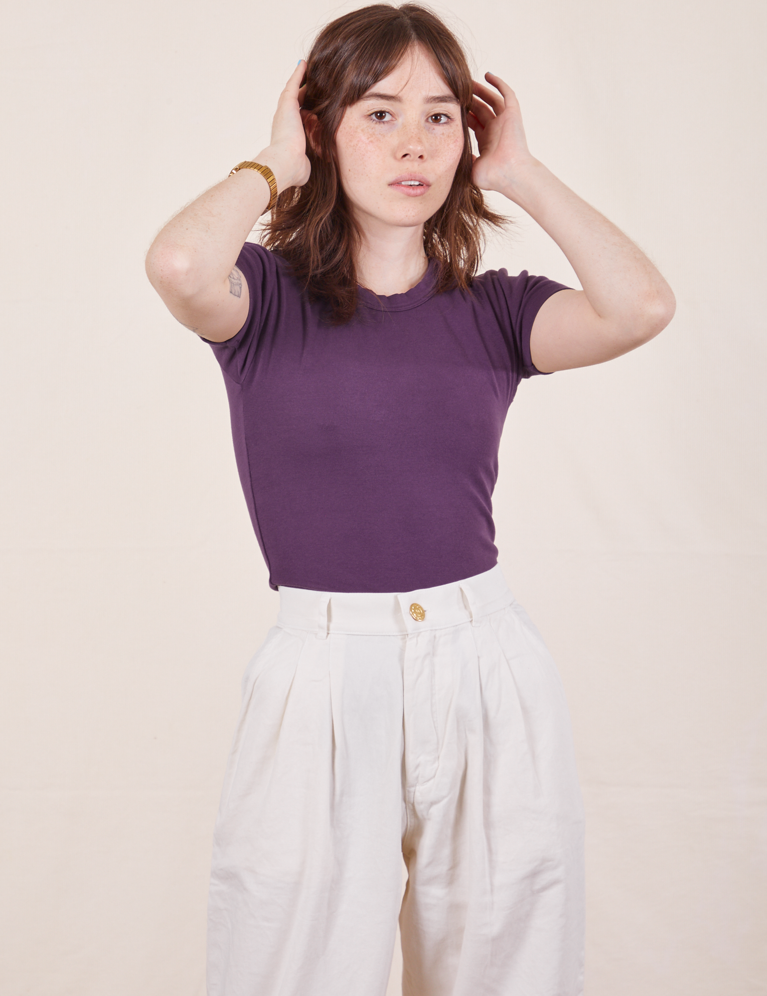 Hana is wearing Baby Tee in Nebula Purple and vintage off-white Trousers