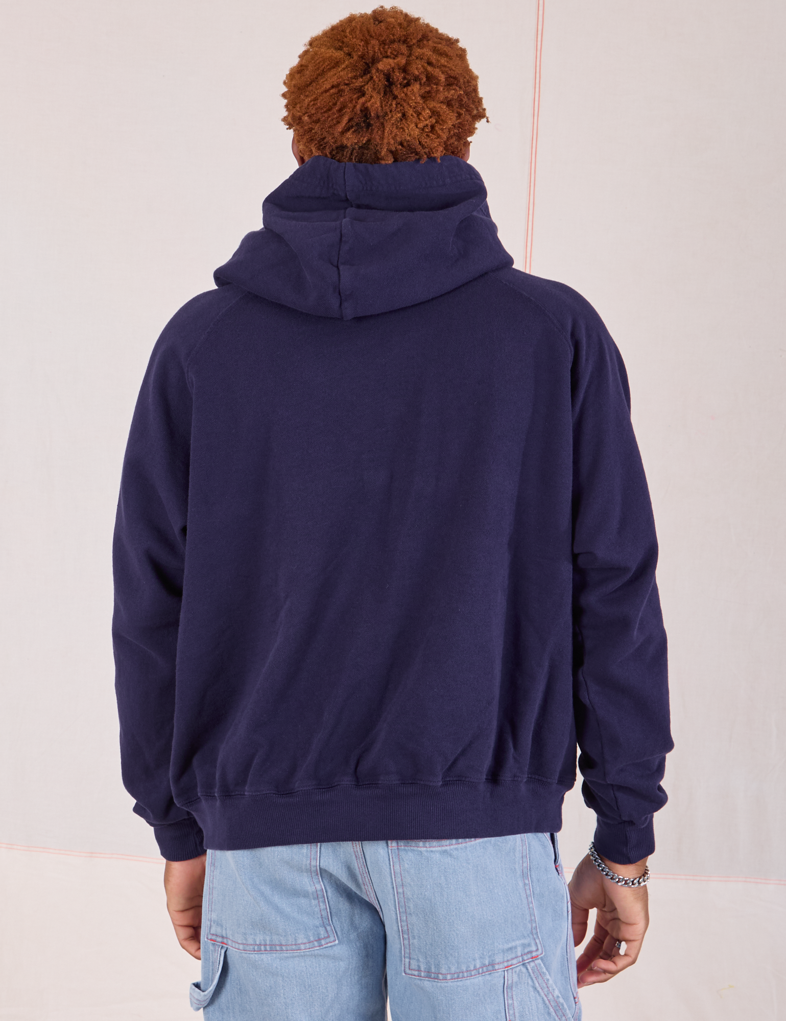 Collegiate Hoodie in Navy Blue back view on Issac