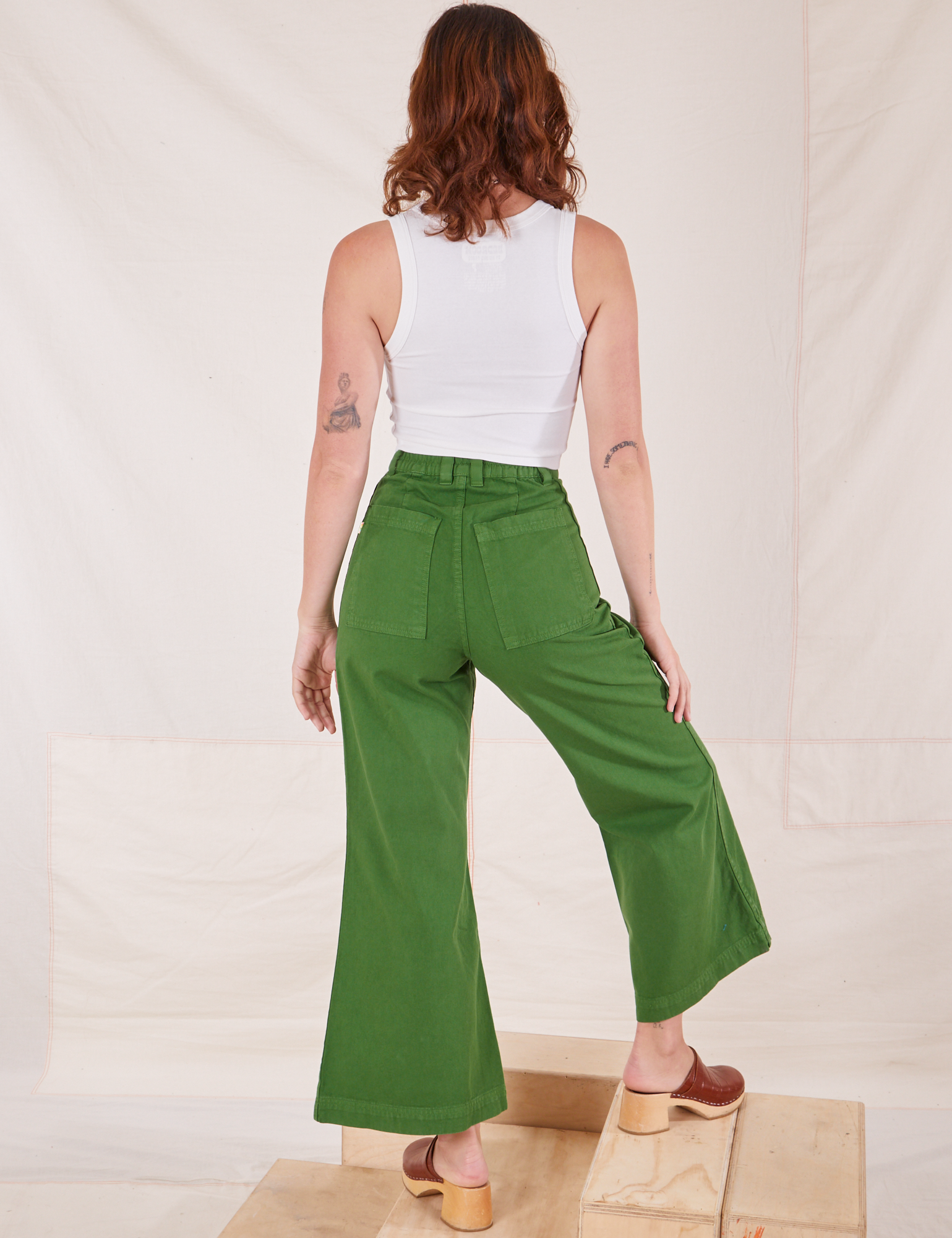 Back view of Bell Bottoms in Lawn Green and vintage off-white Cropped Tank Top on Alex