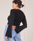 Angled back view of Bell Sleeve Top in Basic Black worn by Tiara
