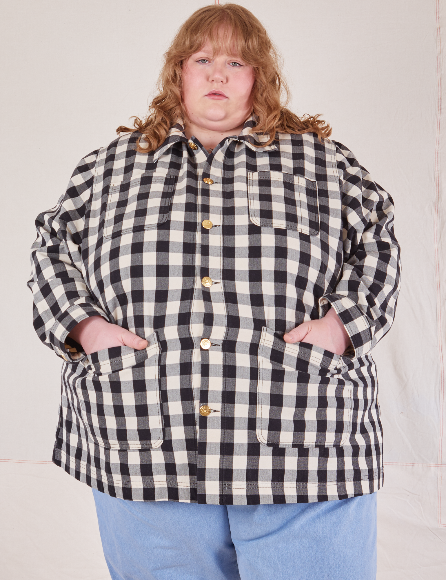 Catie is wearing a buttoned up Big Gingham Field Coat
