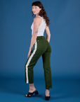 Angled front view of Painted Work Pants in Evergreen and vintage tee white Cropped Tank on Alex