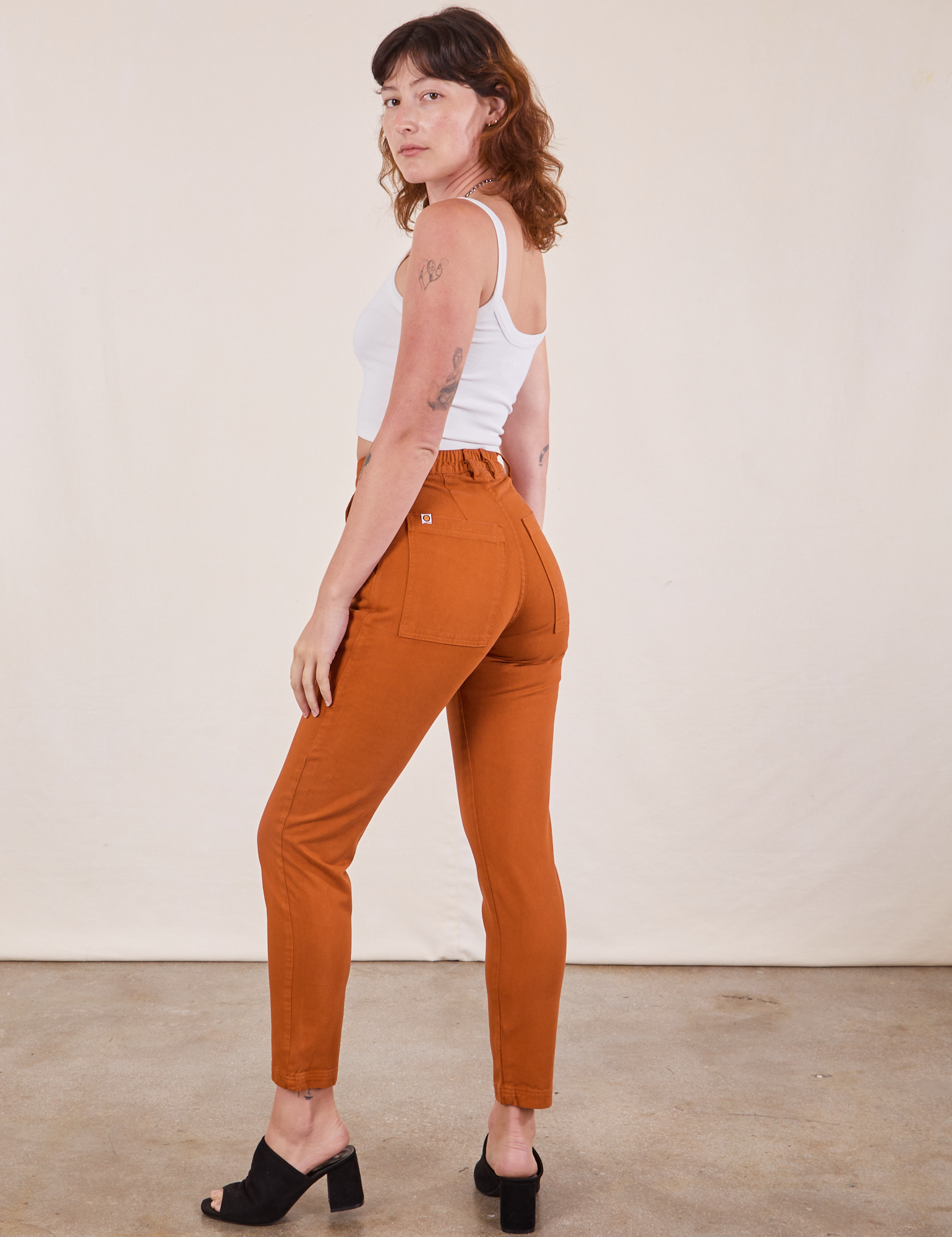 Angled back view of Pencil Pants in Burnt Terracotta on Alex