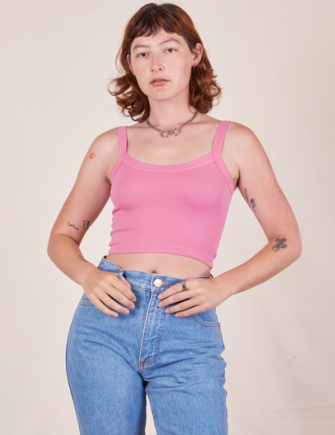 Alex is wearing Cropped Cami in Bubblegum Pink and light wash Frontier Jeans