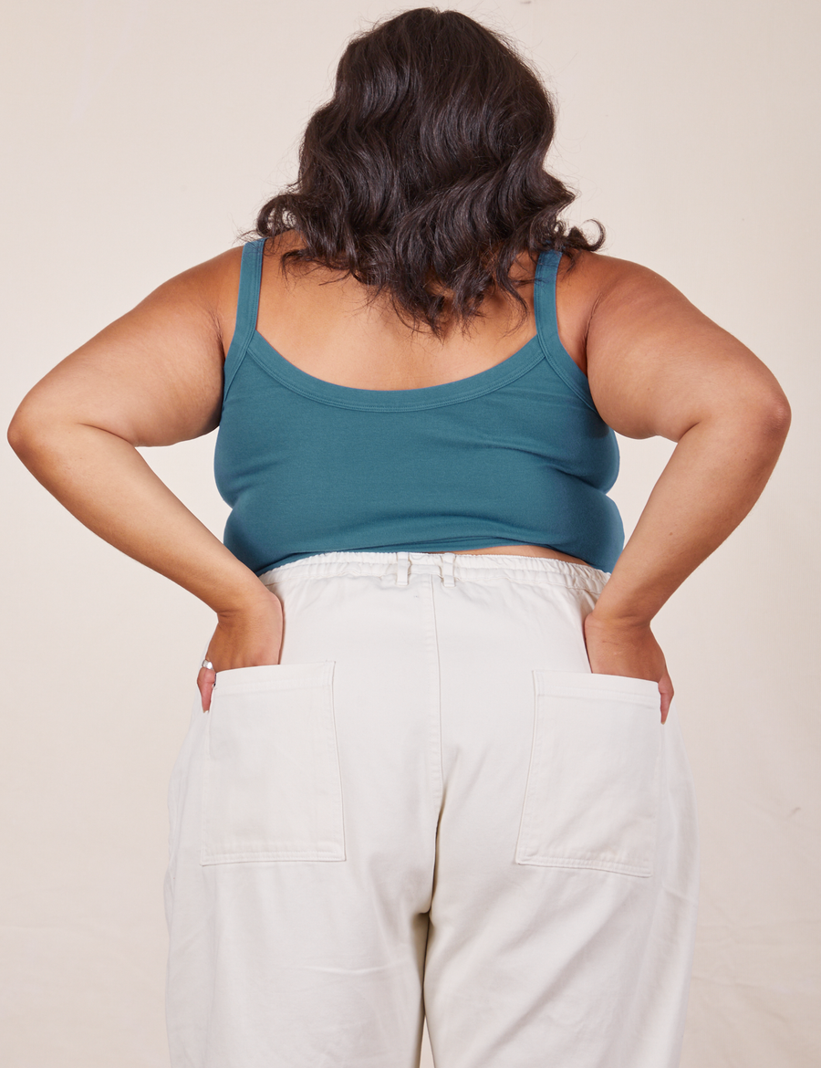 Back view of Cropped Cami in Marine Blue and vintage off-white Western Pants worn by Alicia. She has both hands in the back pant pockets.