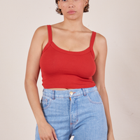Tiara is 5'4" and wearing XS Cropped Cami in Mustang Red paired with light wash Sailor Jeans