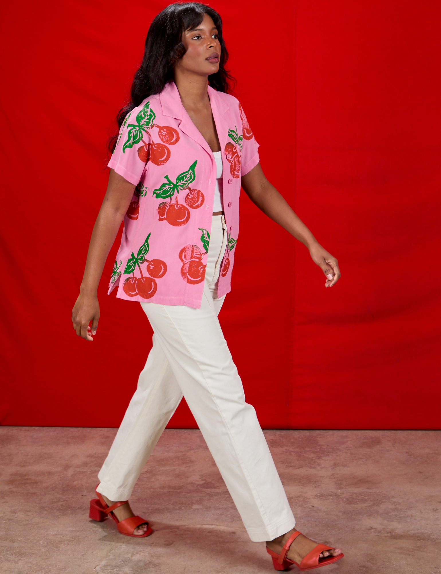 Kandia is waering Cherry Pantry Button-Up and Western Pants in vintage tee off-white