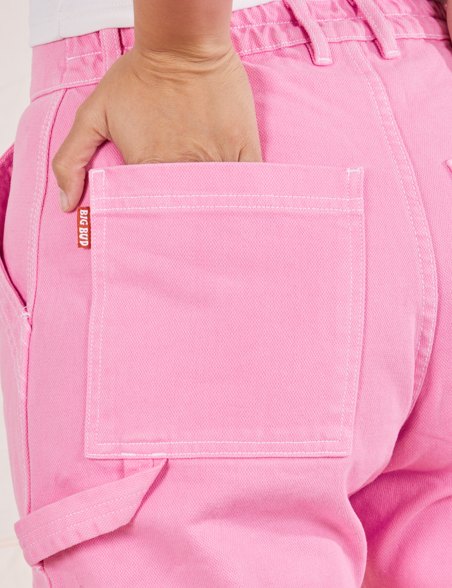 Carpenter Jeans in Bubblegum Pink back pocket close up. Tiara has her hand in the pocket.