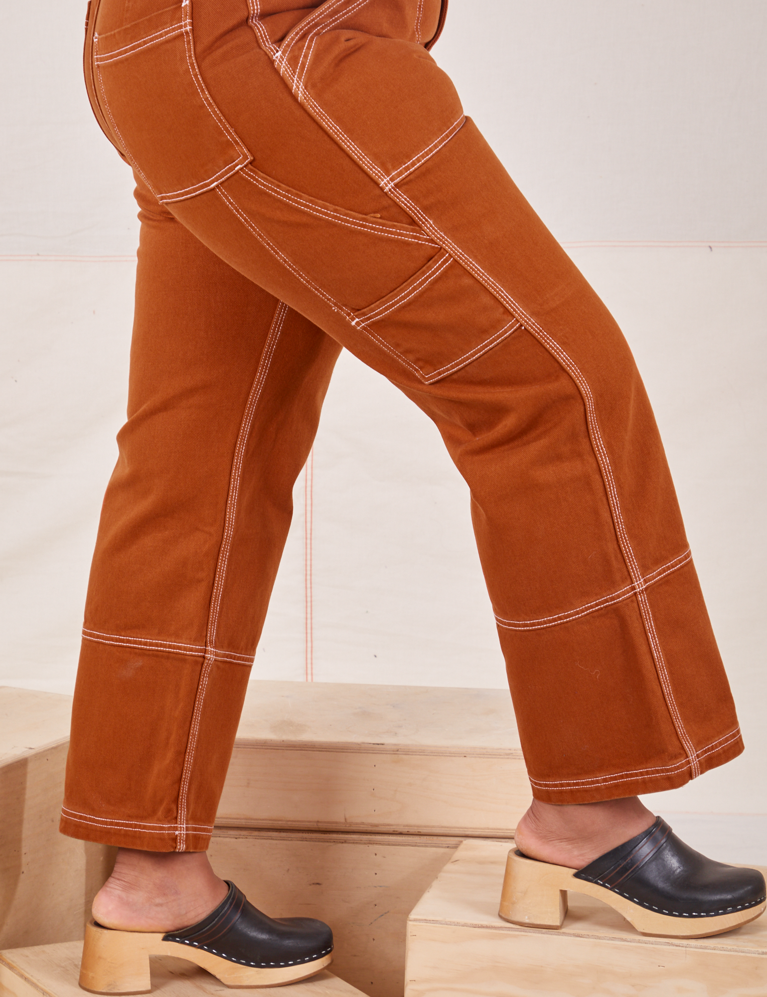 Carpenter Jeans in Burnt Terracotta side close up on Meghna
