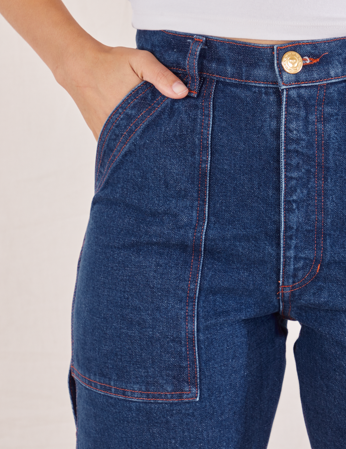 Carpenter Jeans in Dark Wash front pocket close up. Tiara has her hand in the pocket