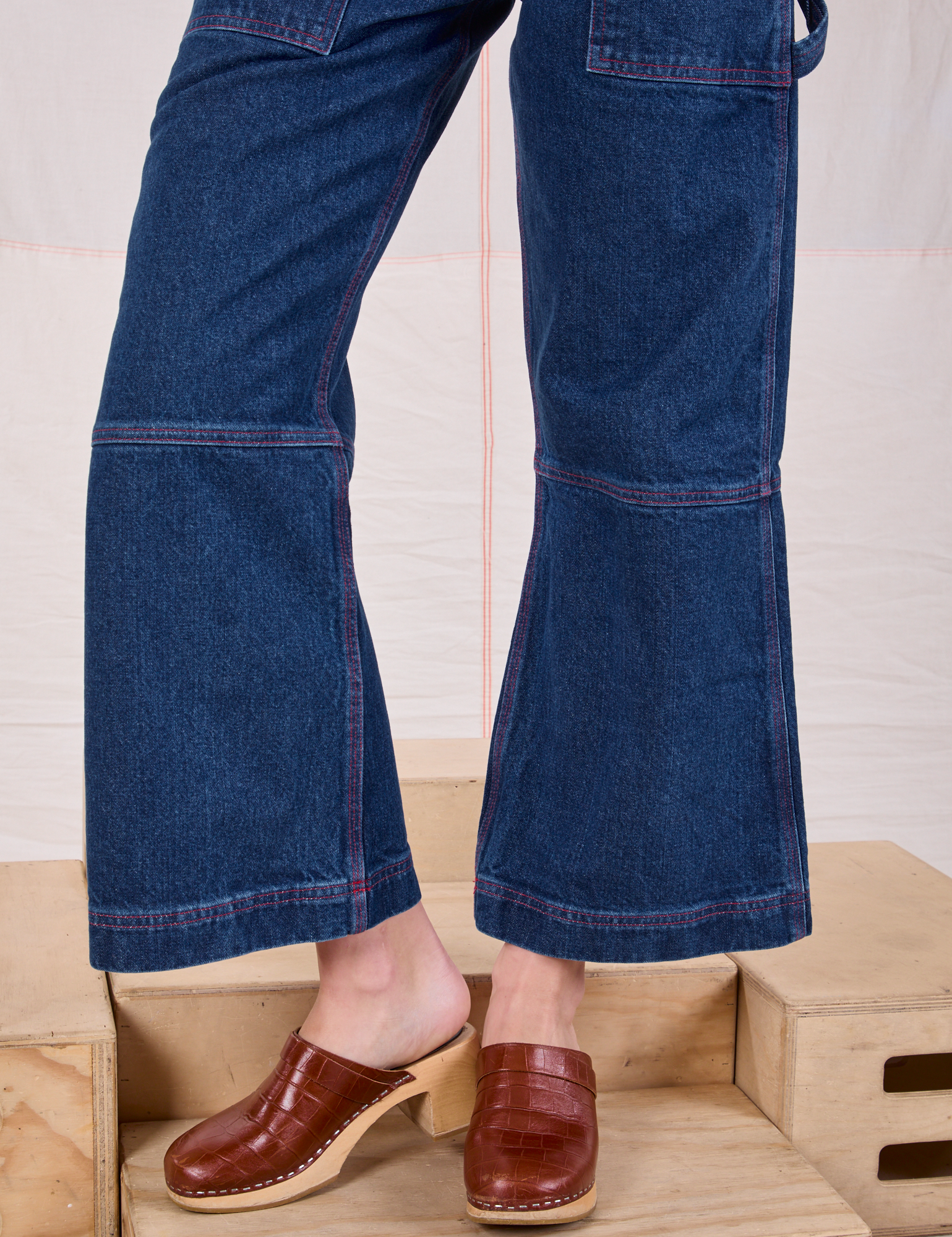 Carpenter Overalls in Dark Wash pant leg close up on Alex