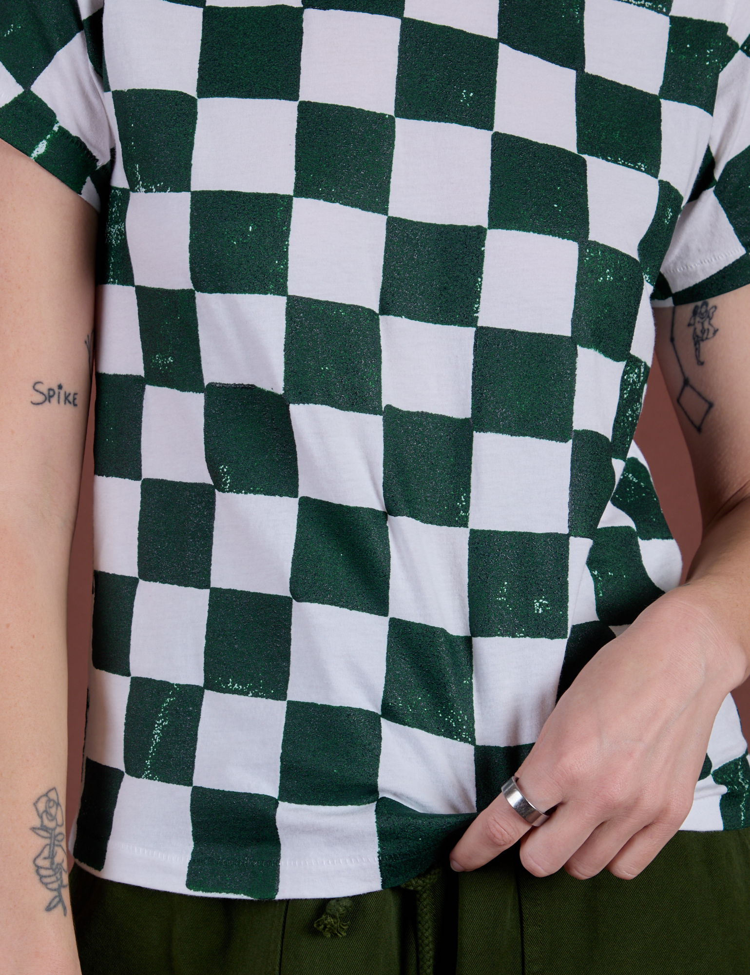 Front close up of Checker Organic Tee in Swamp Green on Alex