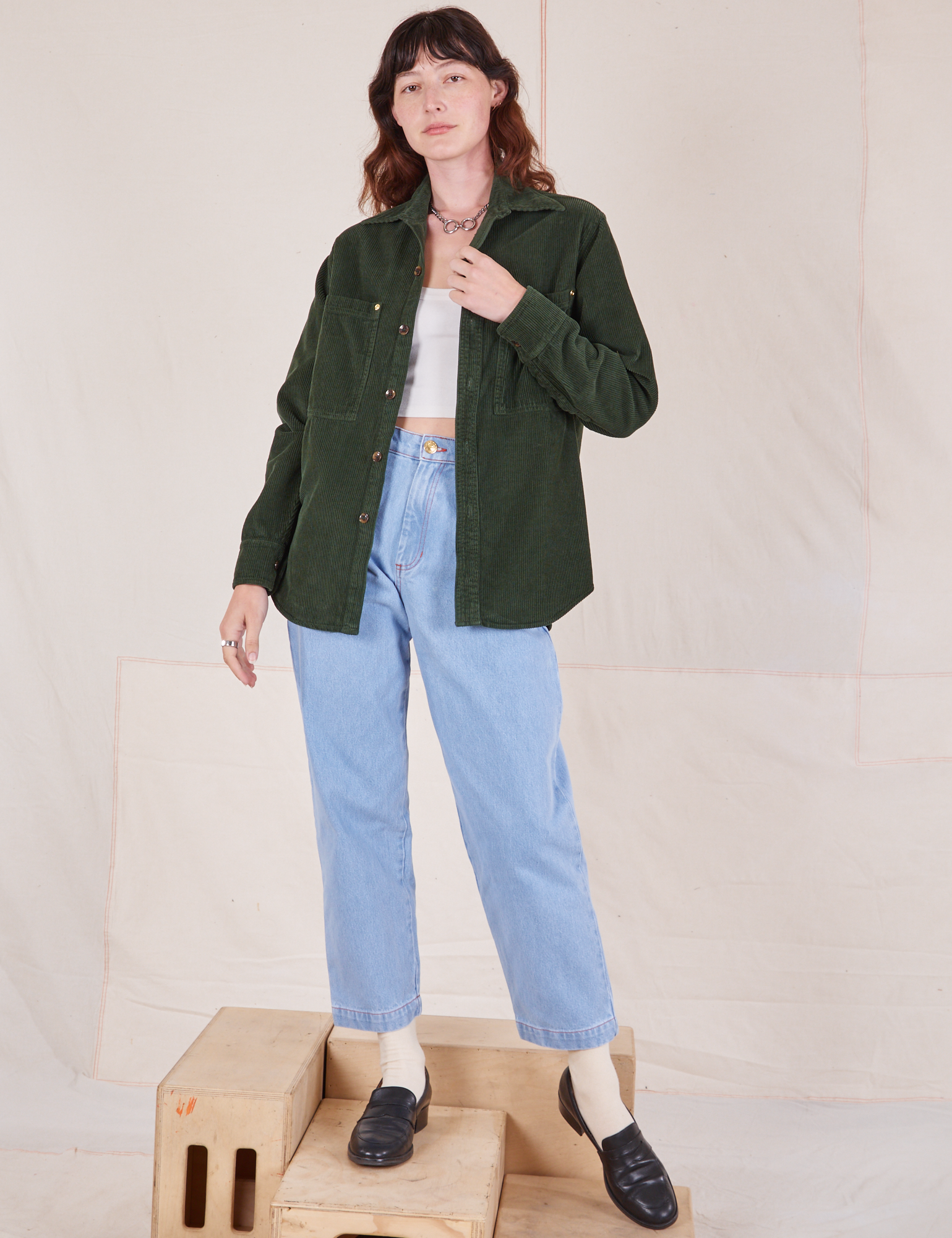 Alex is wearing Corduroy Overshirt in Swamp Green and light wash Denim Trouser Jeans