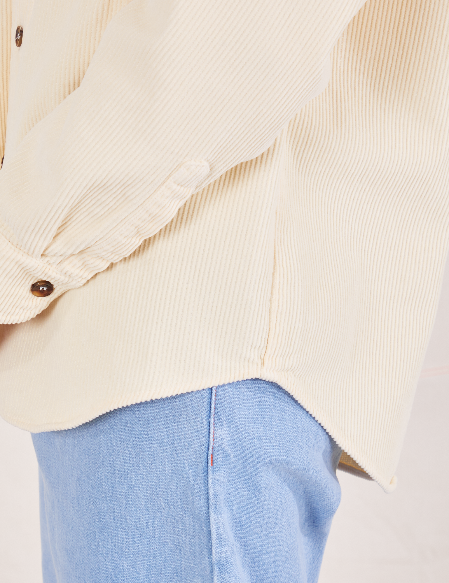 Corduroy Overshirt in Vintage Off-White side close up of curved hem