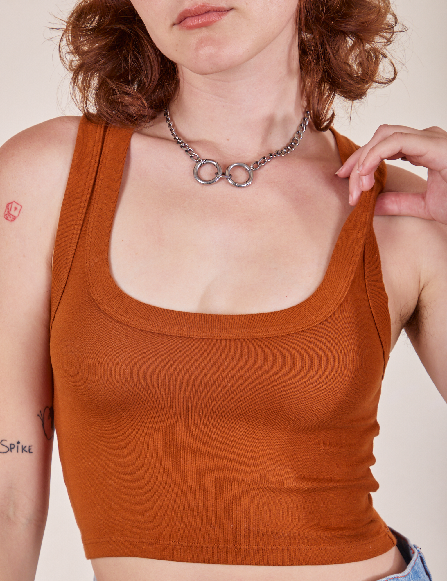 Front close up of Cropped Tank Top in Burnt Terracotta worn by Alex